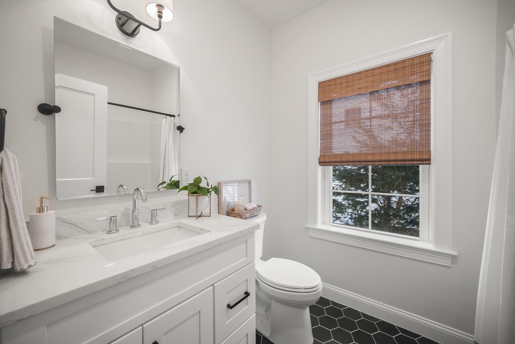 16 Clinton Street Marlborough, MA 01752 - Photo 26 of 39 a bathroom with a granite countertop sink mirror vanity and next to a window