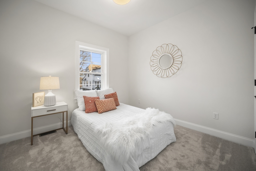16 Clinton Street Marlborough, MA 01752 - Photo 27 of 39 a bedroom with a bed and a window