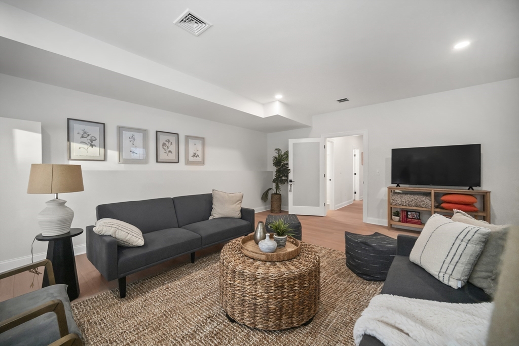 16 Clinton Street Marlborough, MA 01752 - Photo 29 of 39 a living room with furniture and a flat screen tv