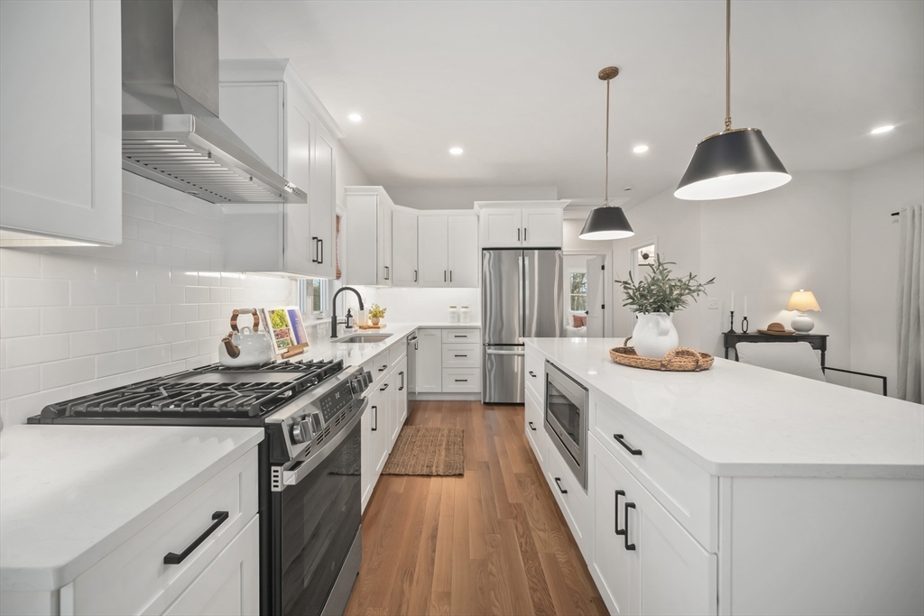 16 Clinton Street Marlborough, MA 01752 - Photo 9 of 39 a kitchen with kitchen island stainless steel appliances a stove a sink a refrigerator and cabinets