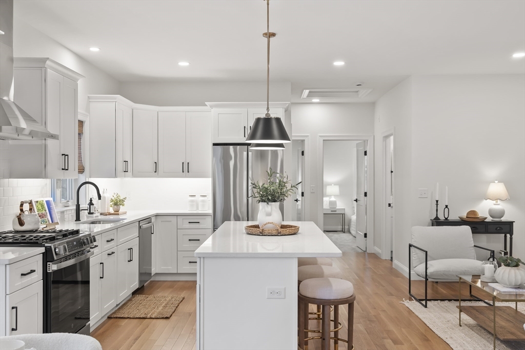 16 Clinton Street Marlborough, MA 01752 - Photo 10 of 39 a kitchen with kitchen island granite countertop a sink a stove a refrigerator and cabinets