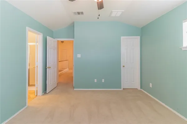 an empty room with windows and closet