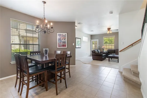a view of a dining room with furniture and a chandelier