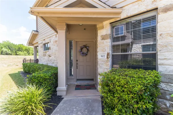 a view of a front door and a potted plant