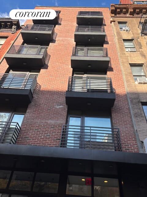 821 9th Avenue, Unit 2C Manhattan, NY 10019 - Photo 1 of 8 a kitchen with a stove and a microwave
