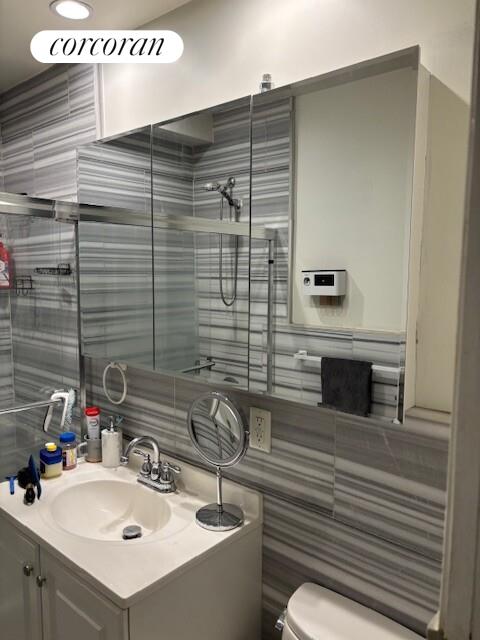 821 9th Avenue, Unit 2C Manhattan, NY 10019 - Photo 7 of 8 a bathroom with a sink and a mirror