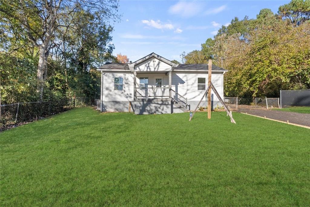 a view of a house with a yard and a garden