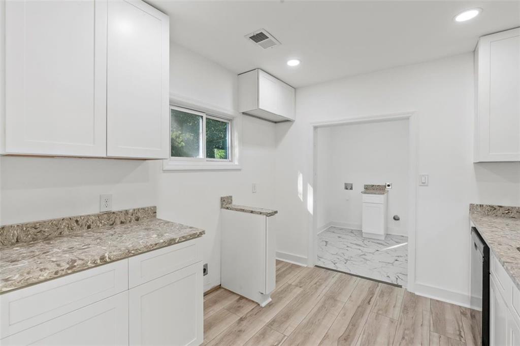 5476 Old Rockbridge Road Stone Mountain, GA 30083 - Photo 11 of 35 a view of kitchen with granite countertop cabinets