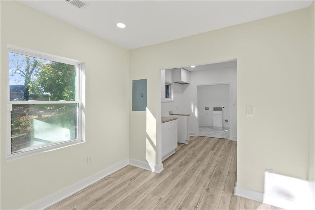 5476 Old Rockbridge Road Stone Mountain, GA 30083 - Photo 12 of 35 a view of a kitchen with wooden floor and a window