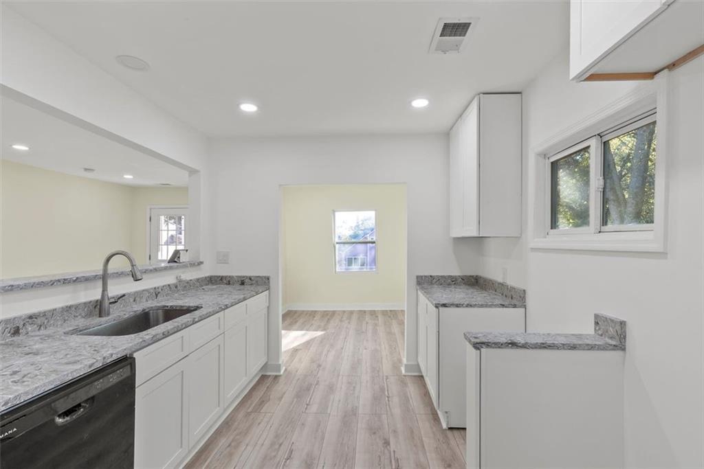 5476 Old Rockbridge Road Stone Mountain, GA 30083 - Photo 13 of 35 a kitchen with a sink stove and cabinets