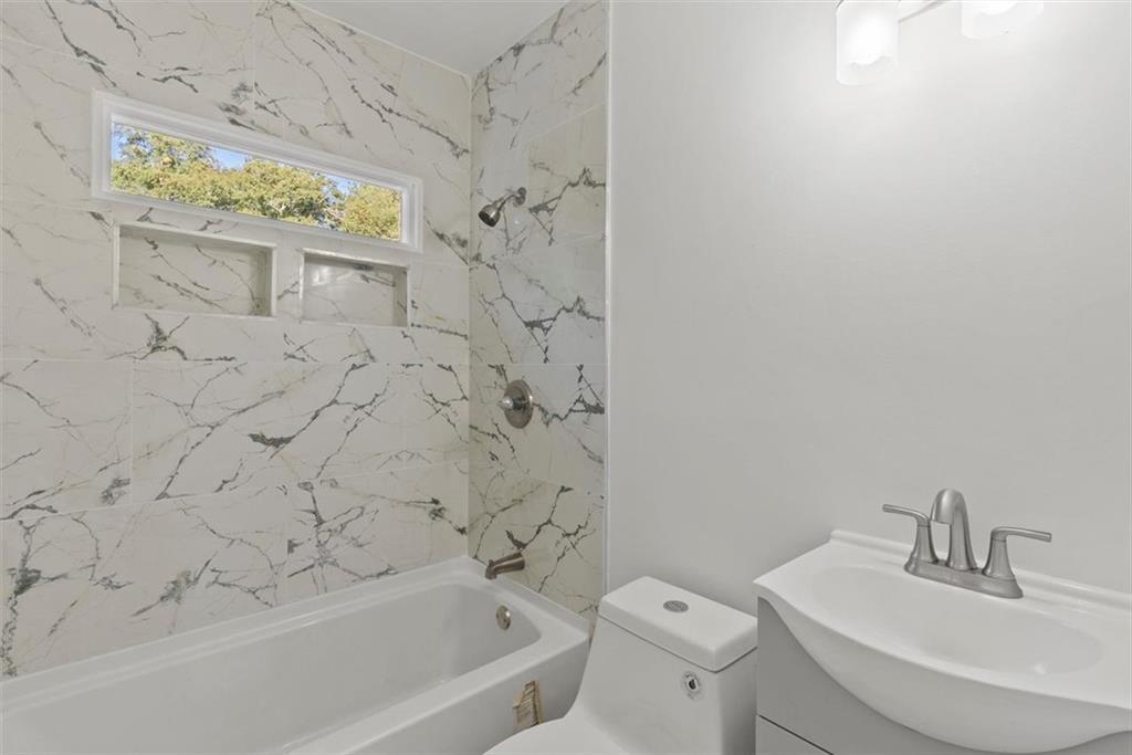 5476 Old Rockbridge Road Stone Mountain, GA 30083 - Photo 15 of 35 a bathroom with a sink a toilet and a bathtub
