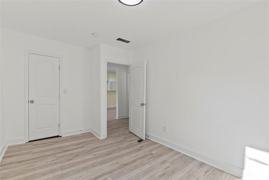 5476 Old Rockbridge Road Stone Mountain, GA 30083 - Photo 17 of 35 a view of an empty room and wooden floor