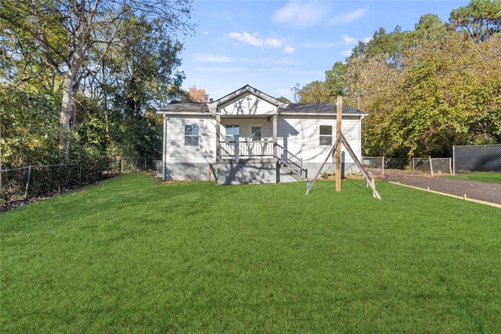 5476 Old Rockbridge Road Stone Mountain, GA 30083 - Photo 20 of 35 a view of a house with a yard and a garden