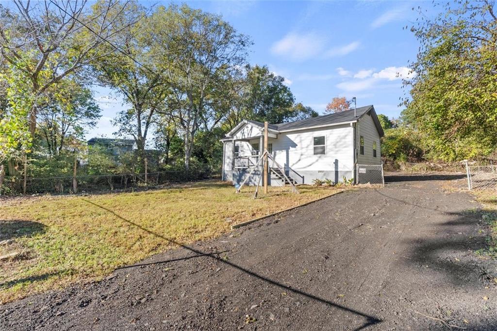 5476 Old Rockbridge Road Stone Mountain, GA 30083 - Photo 24 of 35 a view of a house with a yard