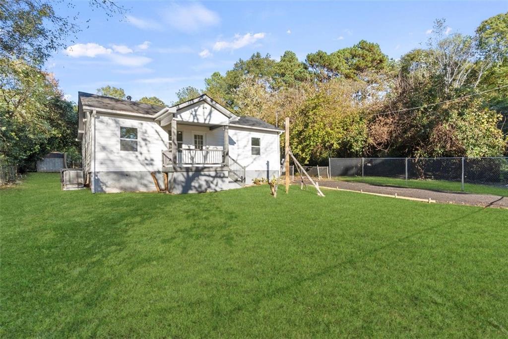 5476 Old Rockbridge Road Stone Mountain, GA 30083 - Photo 29 of 35 a view of a house with a big yard and large trees