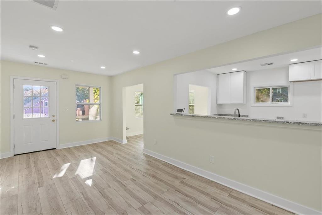 5476 Old Rockbridge Road Stone Mountain, GA 30083 - Photo 3 of 35 a view of a kitchen with wooden floor and a window