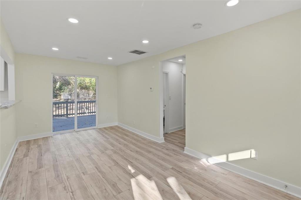 5476 Old Rockbridge Road Stone Mountain, GA 30083 - Photo 6 of 35 a view of wooden floor and windows in a room