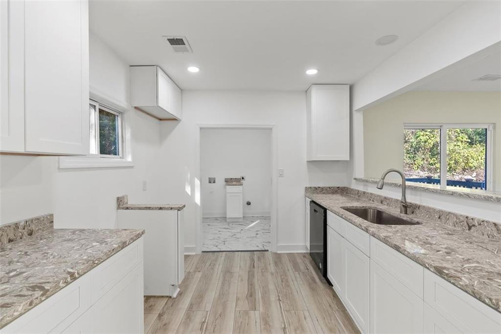 5476 Old Rockbridge Road Stone Mountain, GA 30083 - Photo 8 of 35 a kitchen with a sink stove and cabinets