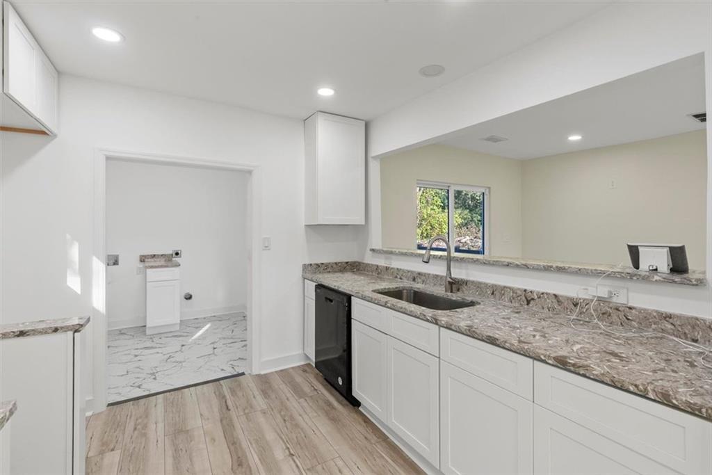 5476 Old Rockbridge Road Stone Mountain, GA 30083 - Photo 9 of 35 a kitchen with a sink stove and cabinets