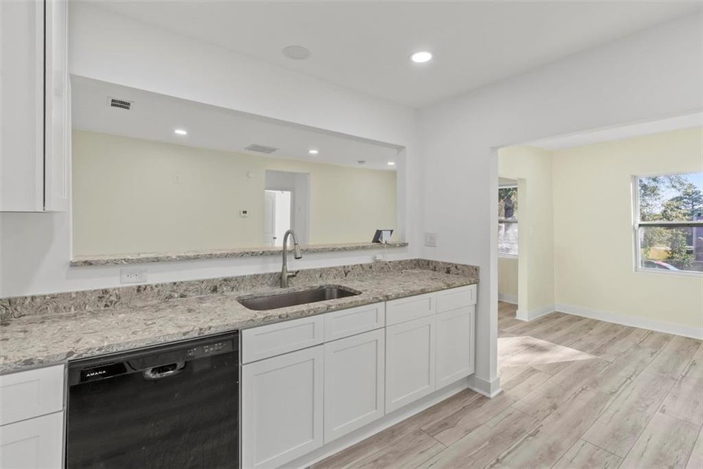 5476 Old Rockbridge Road Stone Mountain, GA 30083 - Photo 10 of 35 a kitchen with a sink cabinets and wooden floor