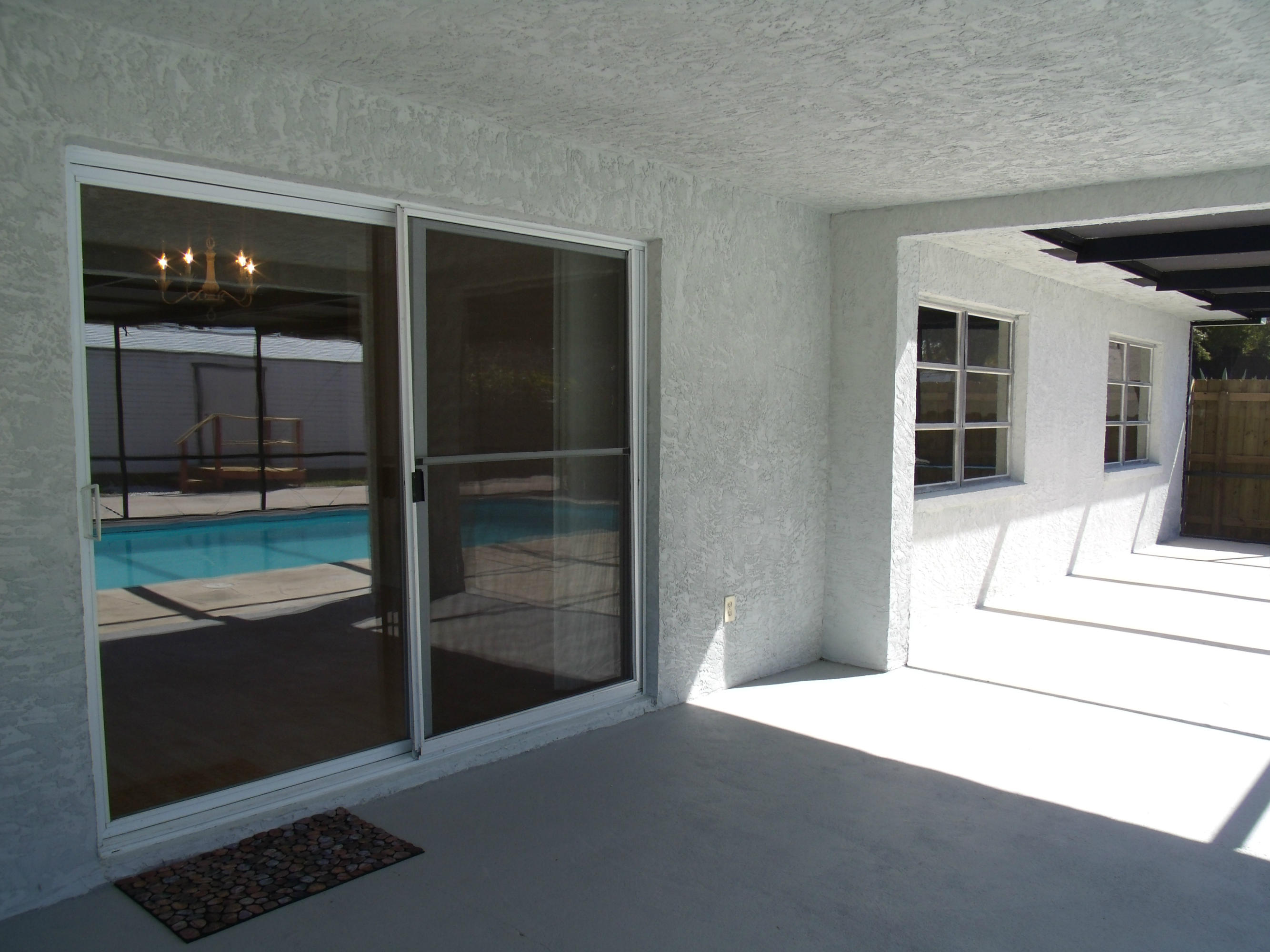 1909 Mayflower Road Fort Pierce, FL 34950 - Photo 23 of 43 Silders to patio & pool area