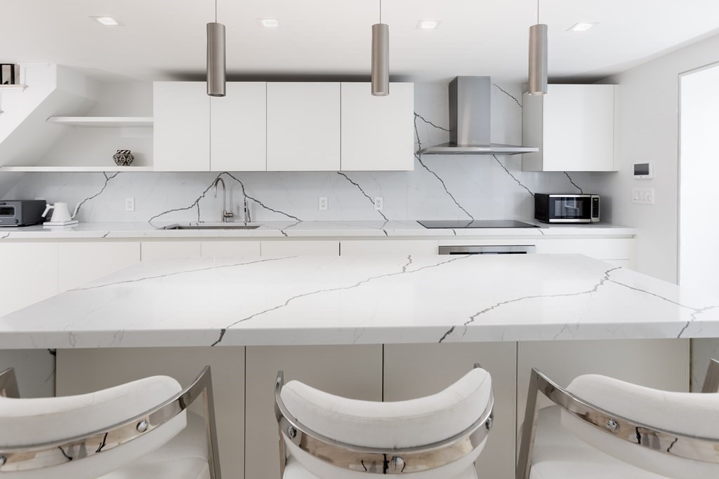 55 Pinckney Street Boston, MA 02114 - Photo 2 of 3 a kitchen with a sink and a stove