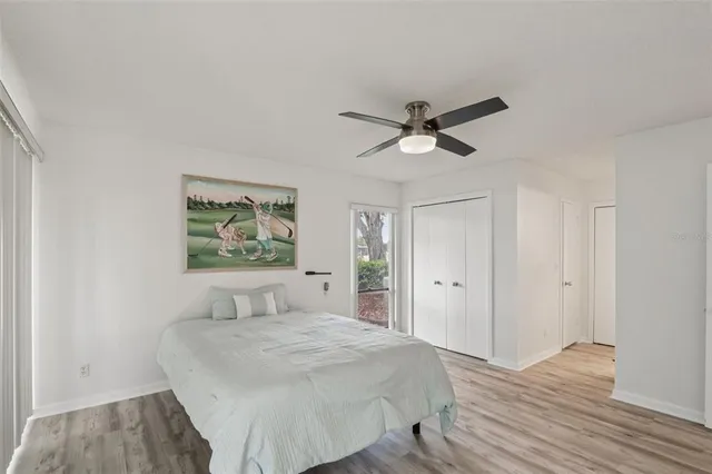 a view of a livingroom with wooden floor and a ceiling fan