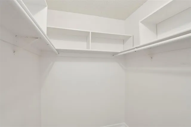 a bathroom with a sink vanity granite tub shower and a mirror