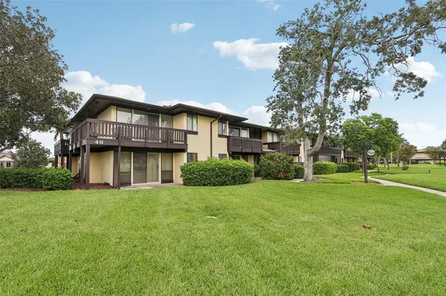 an aerial view of a house with a yard and lake view