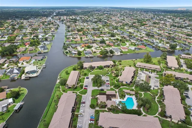 an aerial view of residential building and lake