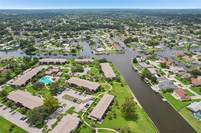 an aerial view of lake and residential houses with outdoor space