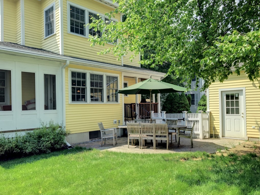 44 Stevens Road Needham, MA 02492 - Photo 12 of 14 a backyard of a house with outdoor seating and a garden