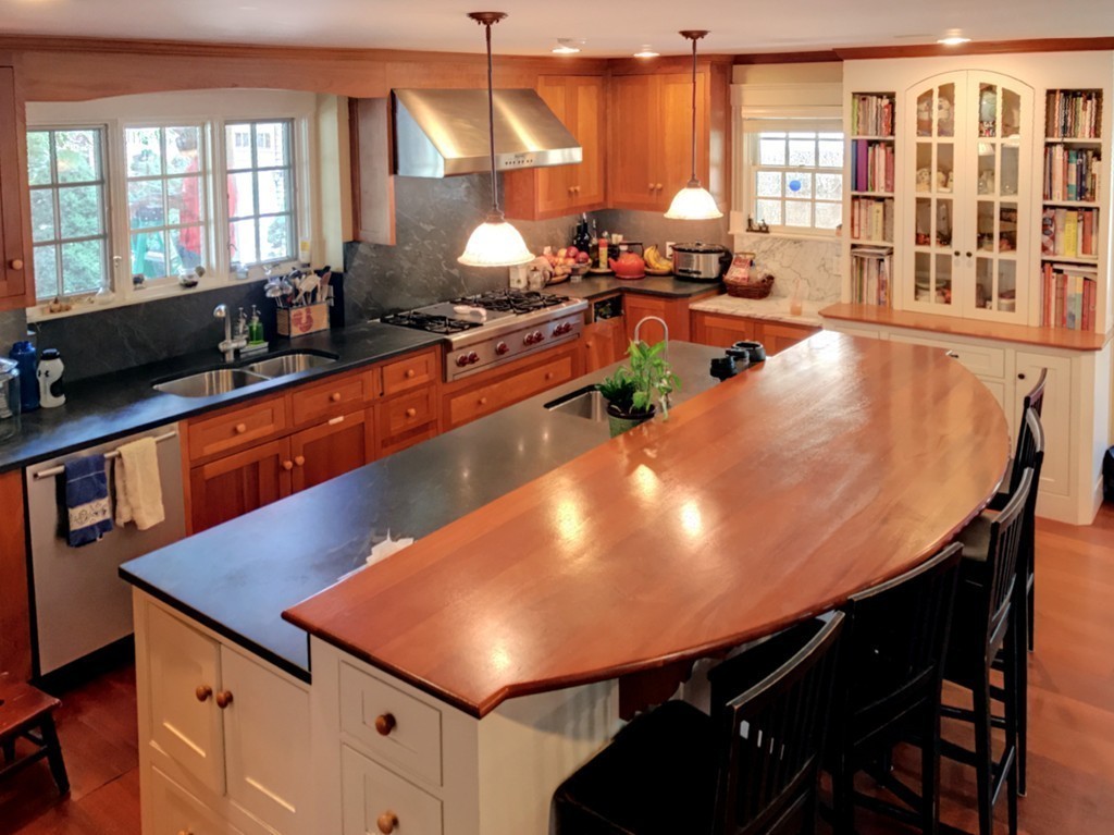 44 Stevens Road Needham, MA 02492 - Photo 5 of 14 a room with stainless steel appliances dining table chairs and large windows