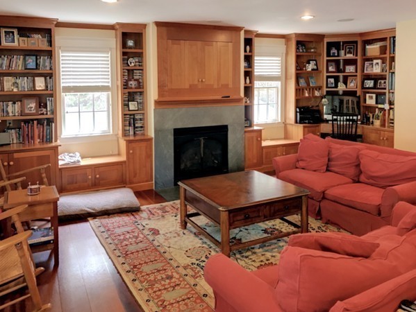 44 Stevens Road Needham, MA 02492 - Photo 8 of 14 a living room with furniture a bookshelf and a fireplace