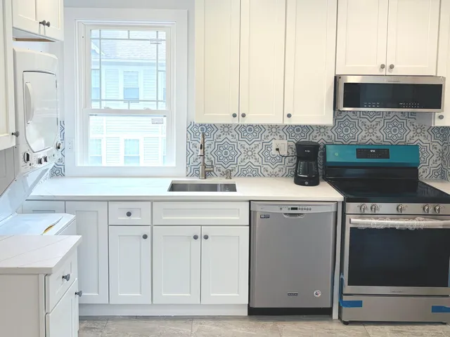 a kitchen with a sink stove and cabinets