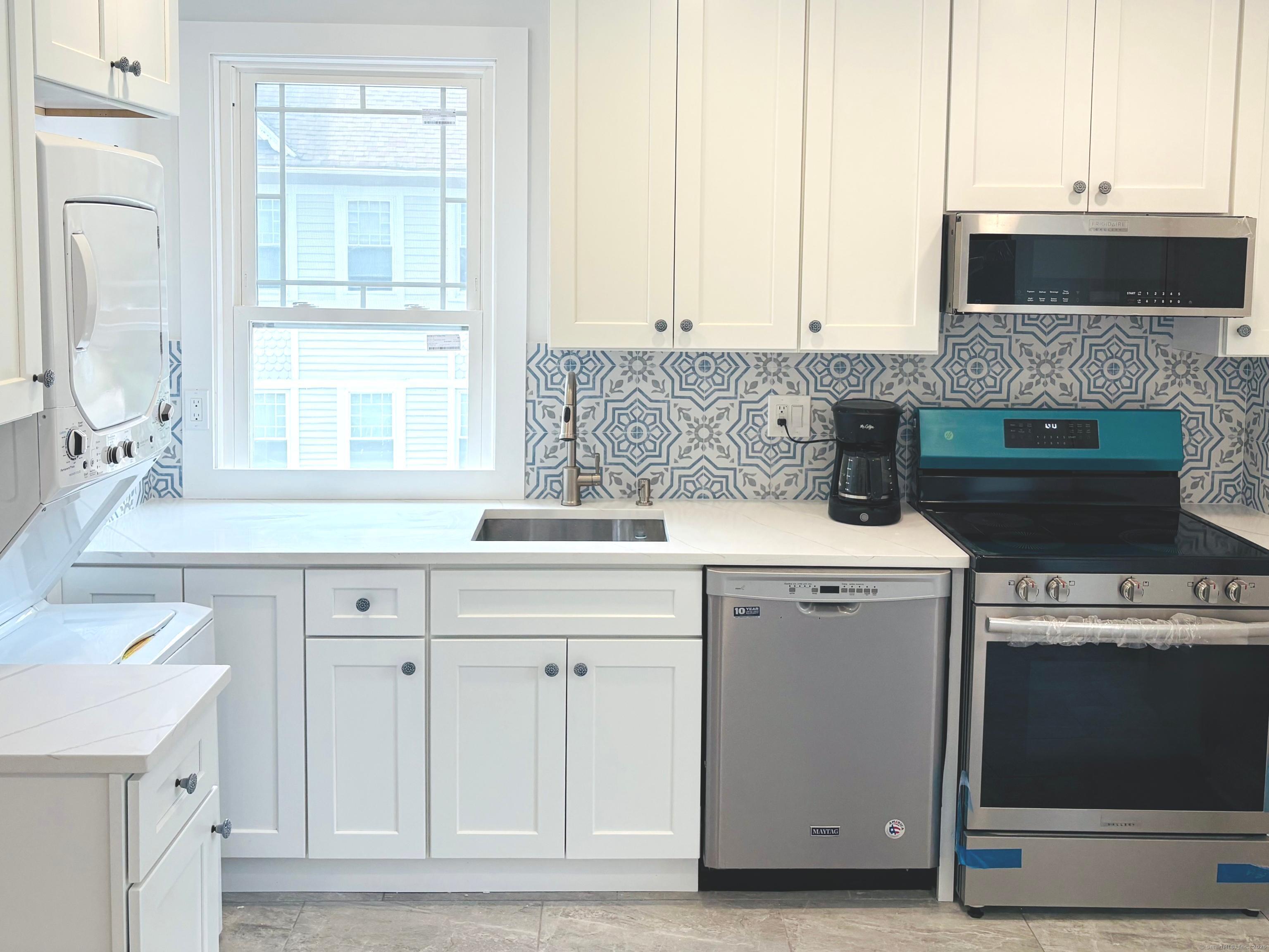a kitchen with a sink stove and cabinets