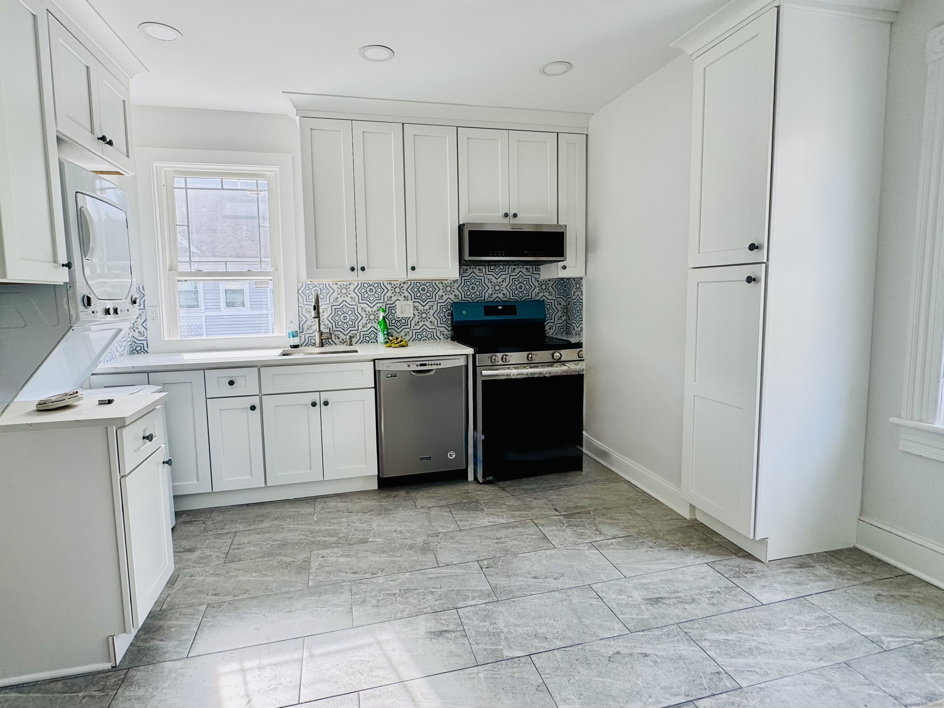 66 Church Lane Westport, CT 06880 - Photo 2 of 22 a kitchen with a stove sink and cabinets
