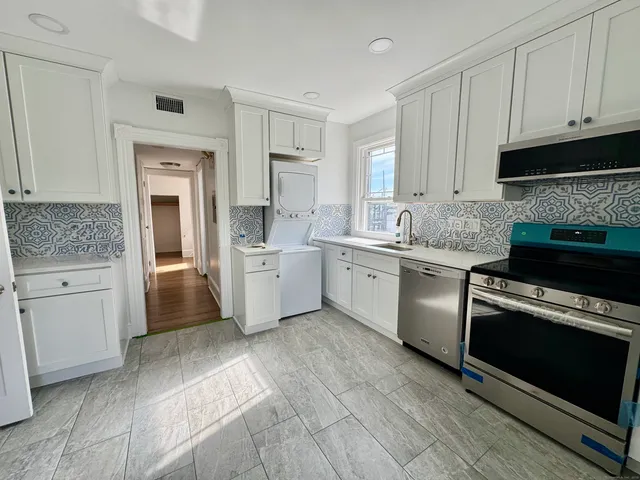 a kitchen with a sink stove and cabinets