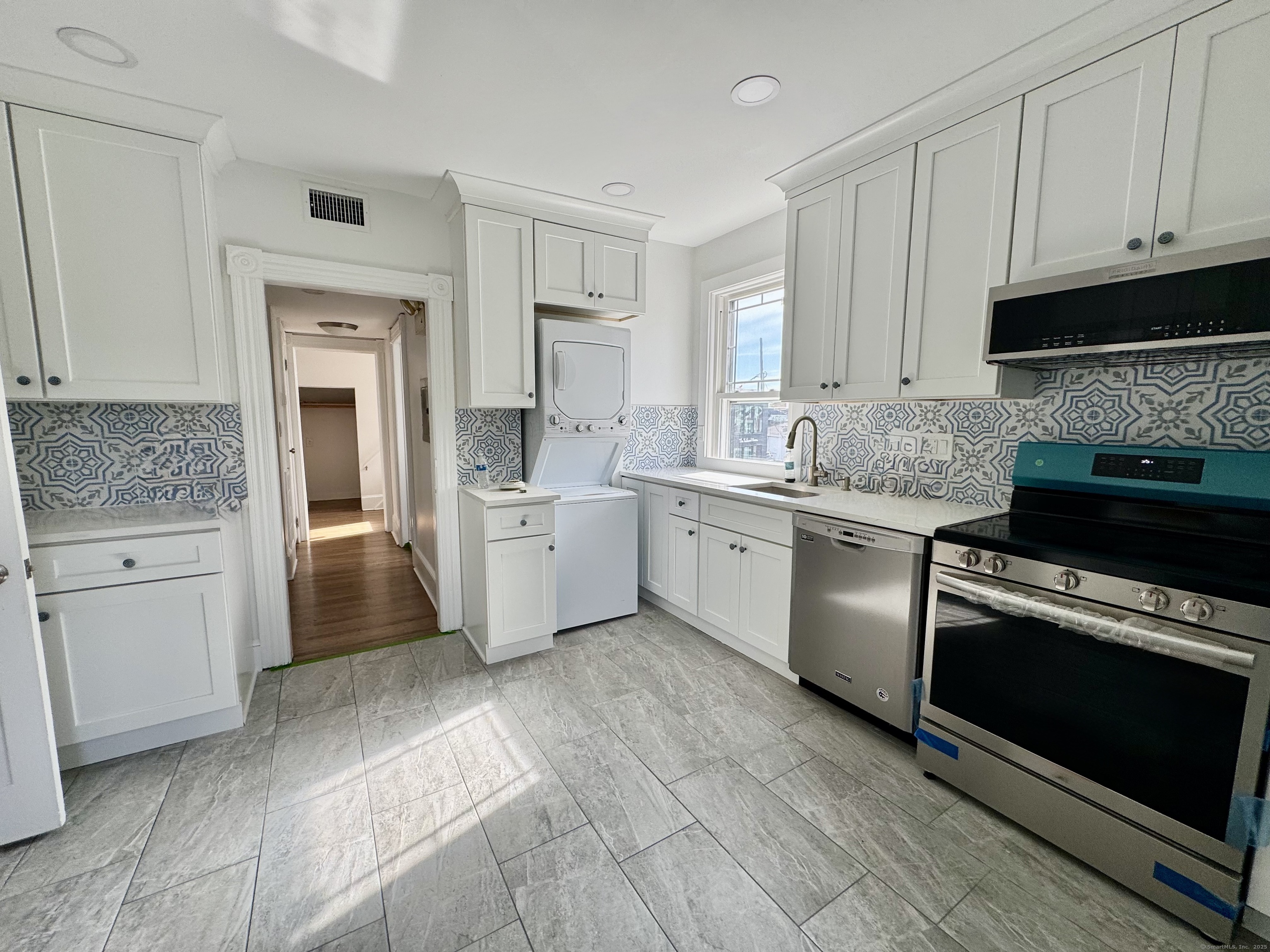 66 Church Lane Westport, CT 06880 - Photo 4 of 22 a kitchen with a sink stove and cabinets