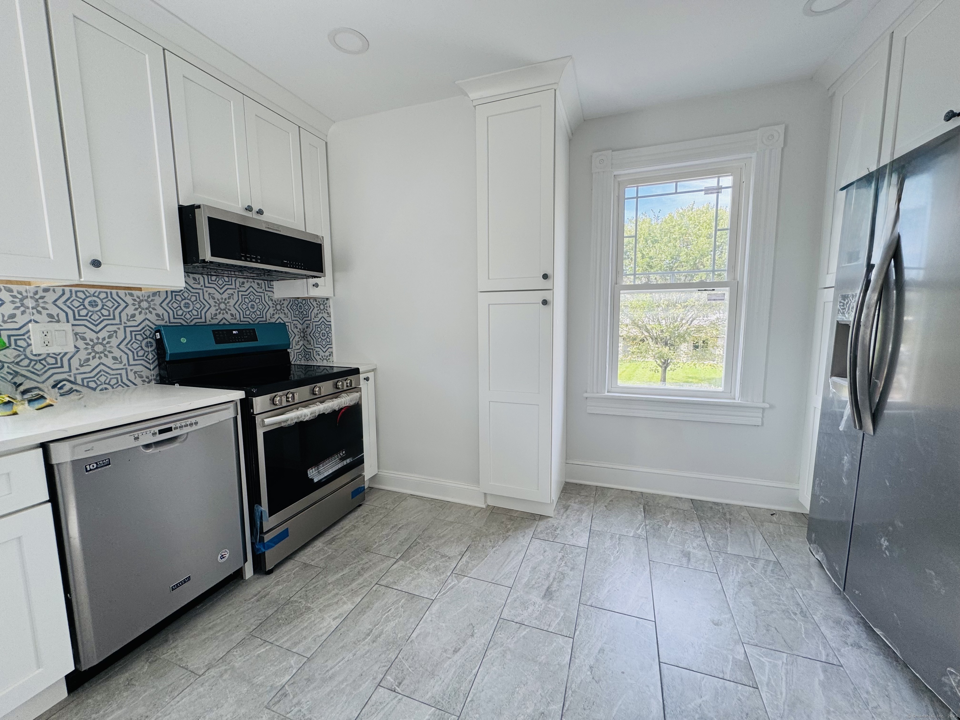 66 Church Lane Westport, CT 06880 - Photo 5 of 22 a kitchen with a stove a sink and a refrigerator