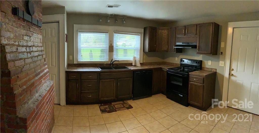317 Tryon Road Rutherfordton, NC 28139 - Photo 4 of 10 a kitchen with a sink window and cabinets