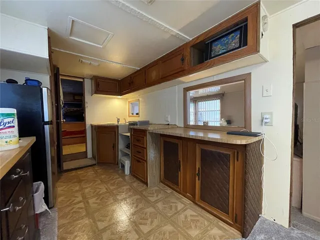 a view of kitchen with cabinets