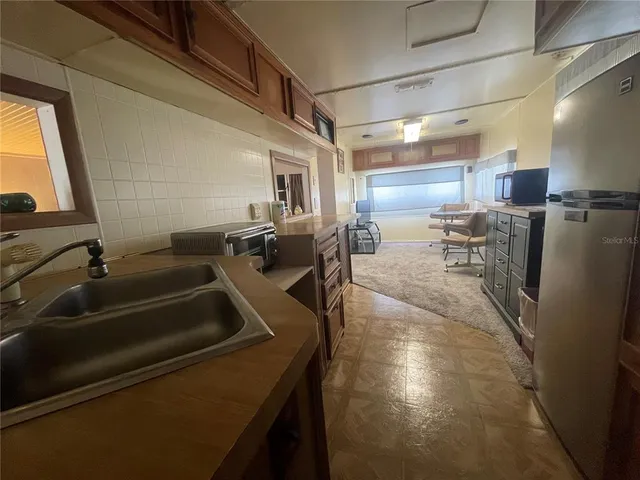 a kitchen with a sink appliances and a counter top