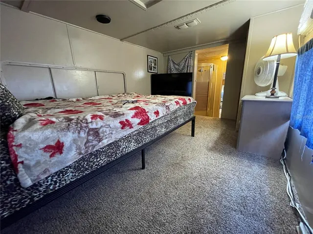 a bedroom with a bed and a view of bathroom