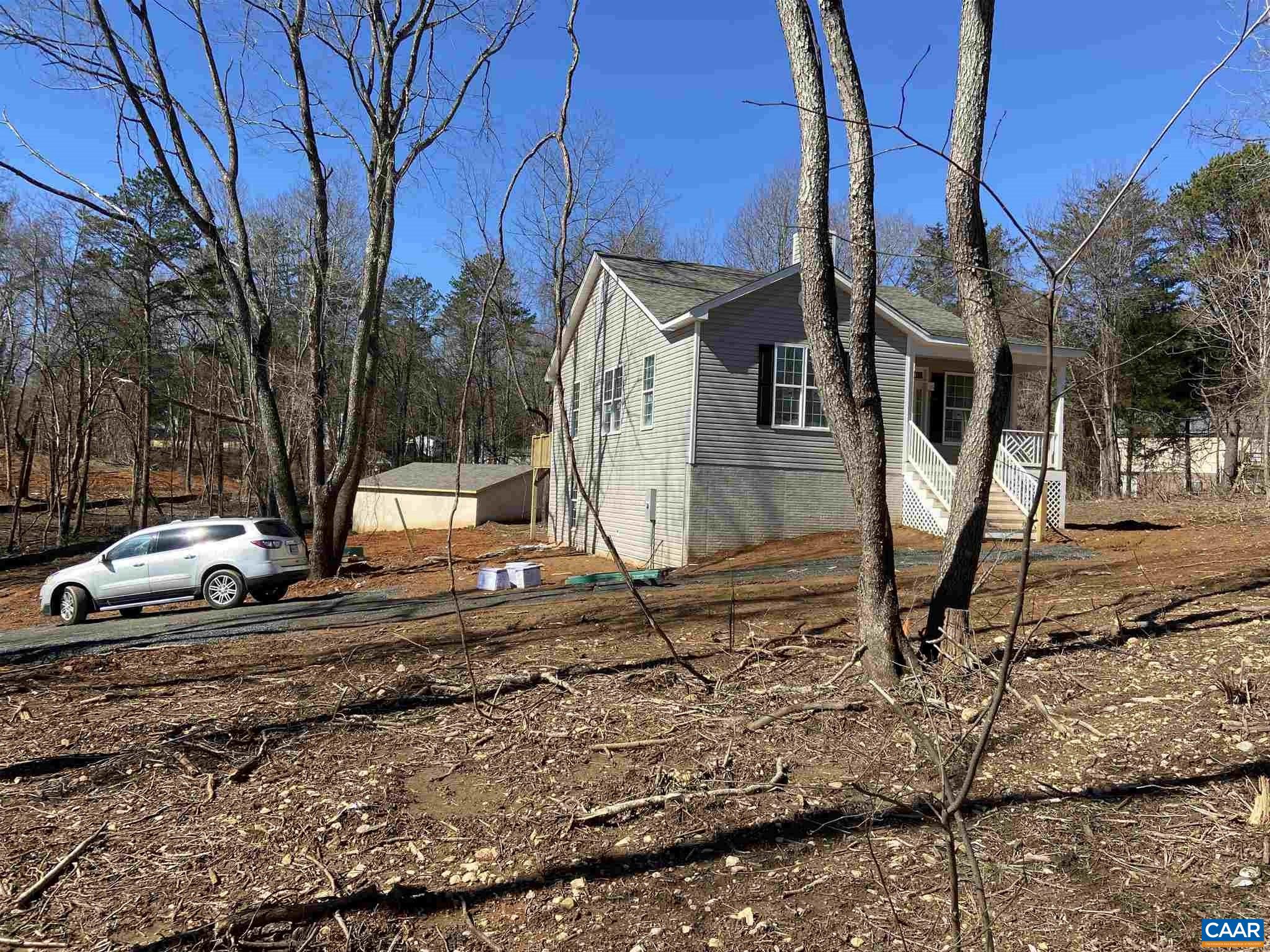 551 West Daffodil Road Ruckersville, VA 22968 - Photo 2 of 20 a view of a backyard with large trees