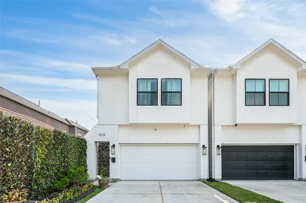 a front view of a house with garage