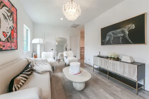 a living room with furniture and a chandelier
