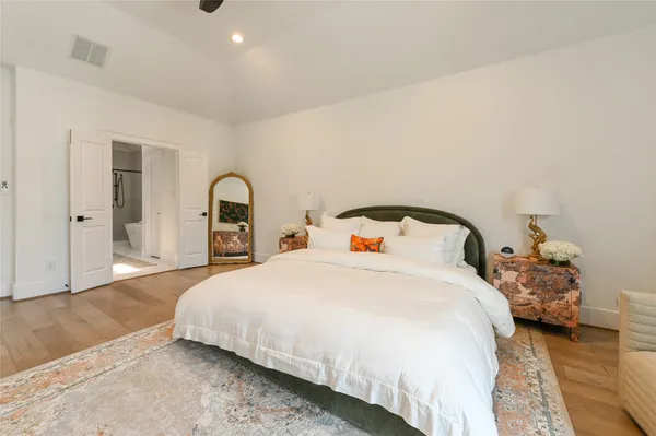 a bedroom with a bed and a large window