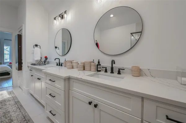 a bathroom with a double vanity sink and a mirror