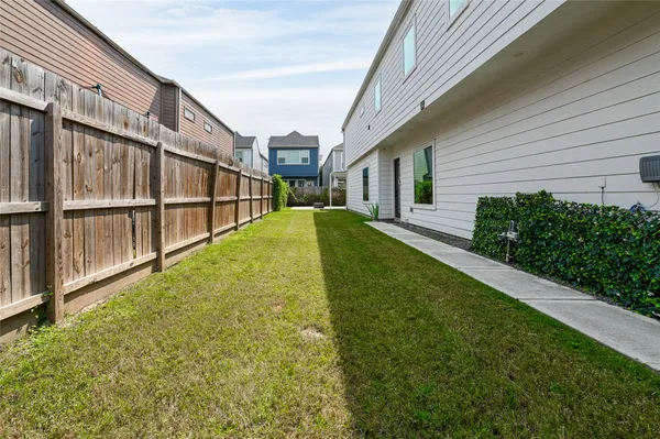 a backyard of a house with yard and outdoor seating
